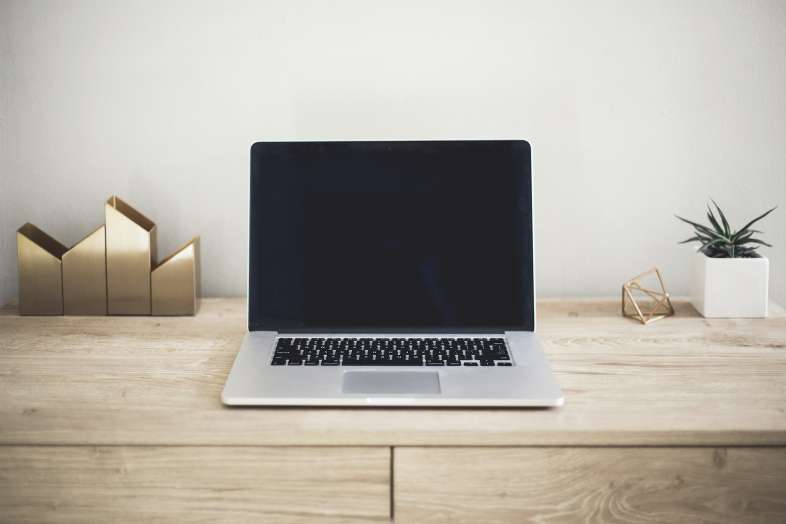 A quiet desktop workspace with a laptop
